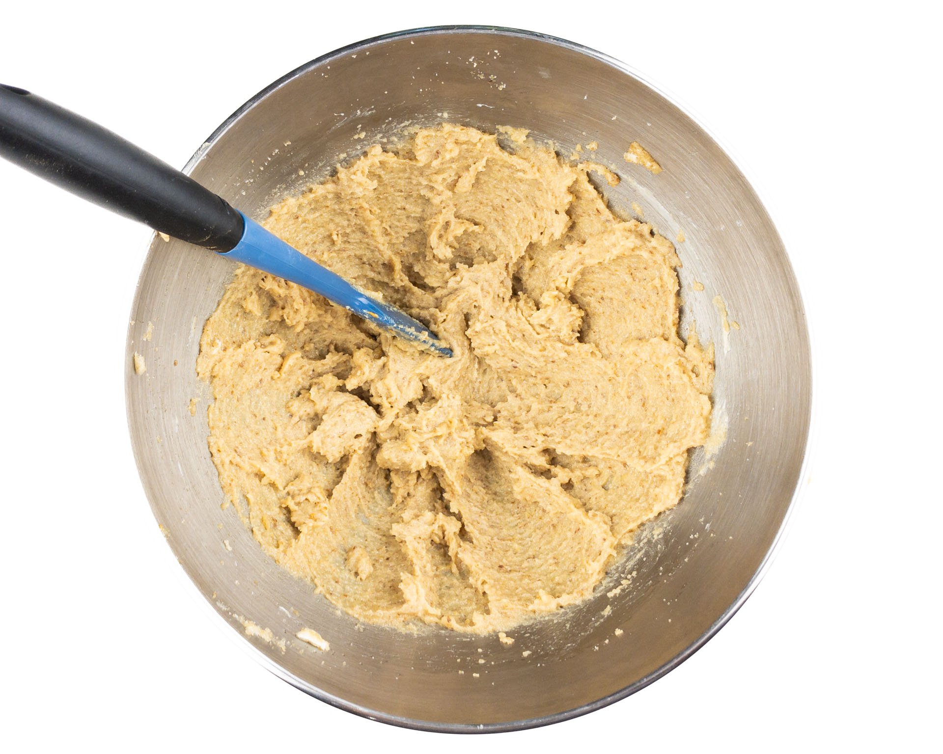 Butter and sugar have been mixed together in the bottom of a mixing bowl.