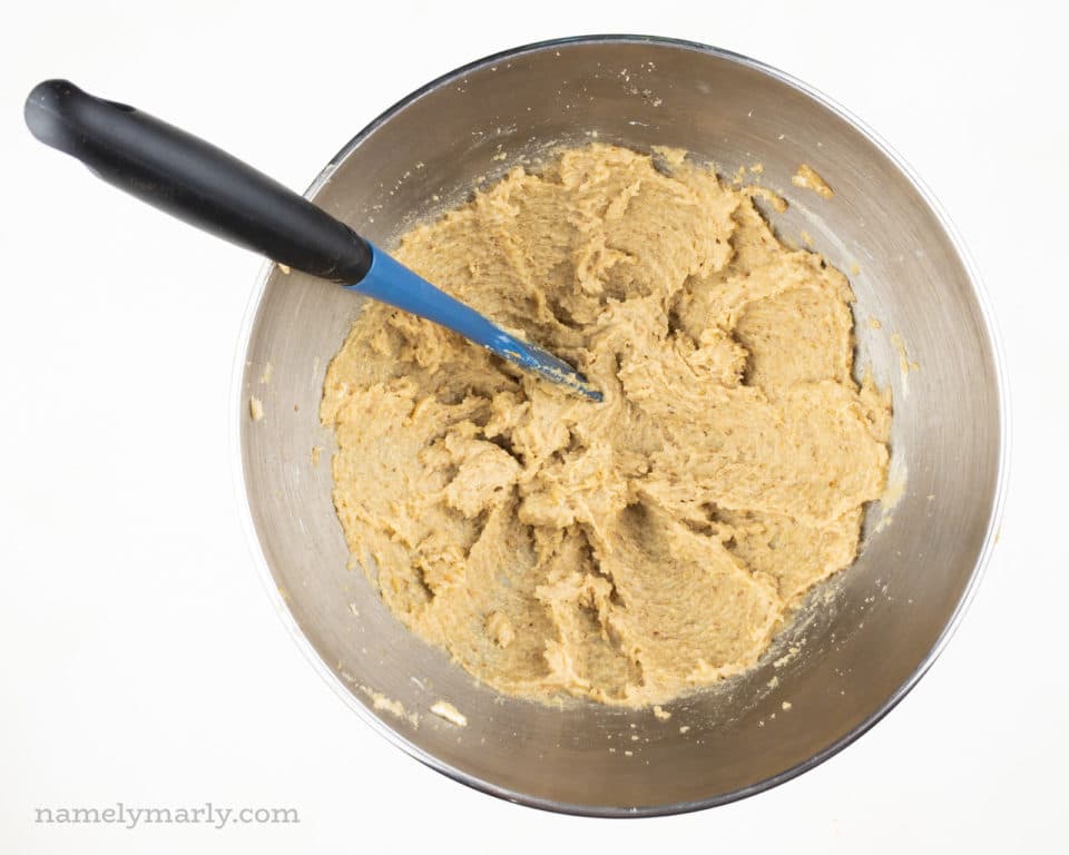 Butter and sugar have been mixed together in the bottom of a mixing bowl.