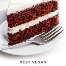 A slice of cake sits in front of the rest of the cake. The text behind it reads, Vegan Red Velvet Cake.