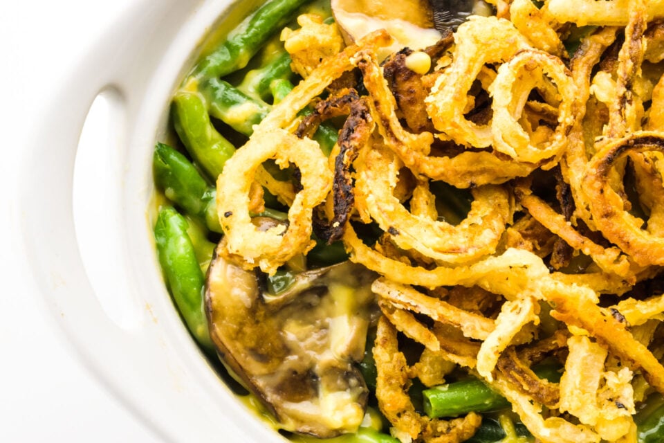 Looking down on the edge of a casserole dish holding green bean casserole.