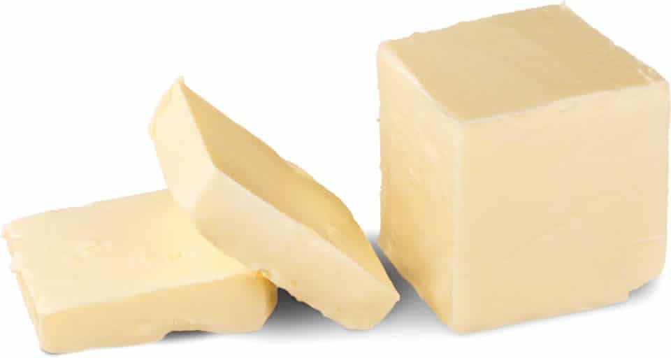A stick of vegan butter has two slices cut out.