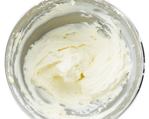 Looking down on a mixing bowl full of fluffy white frosting.