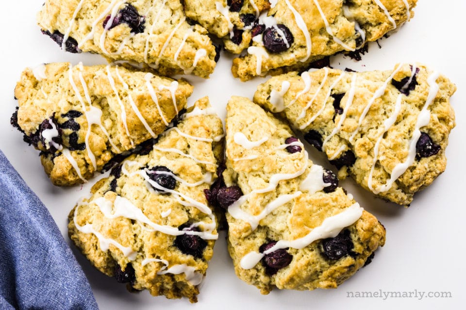 Several triangle shaped scones are pointing towards the center, create a round of scones.
