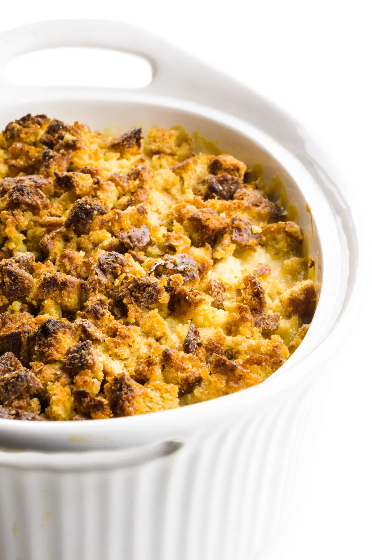 A casserole dish is full of freshly baked cauliflower gratin with a browned bread crumbled topping.