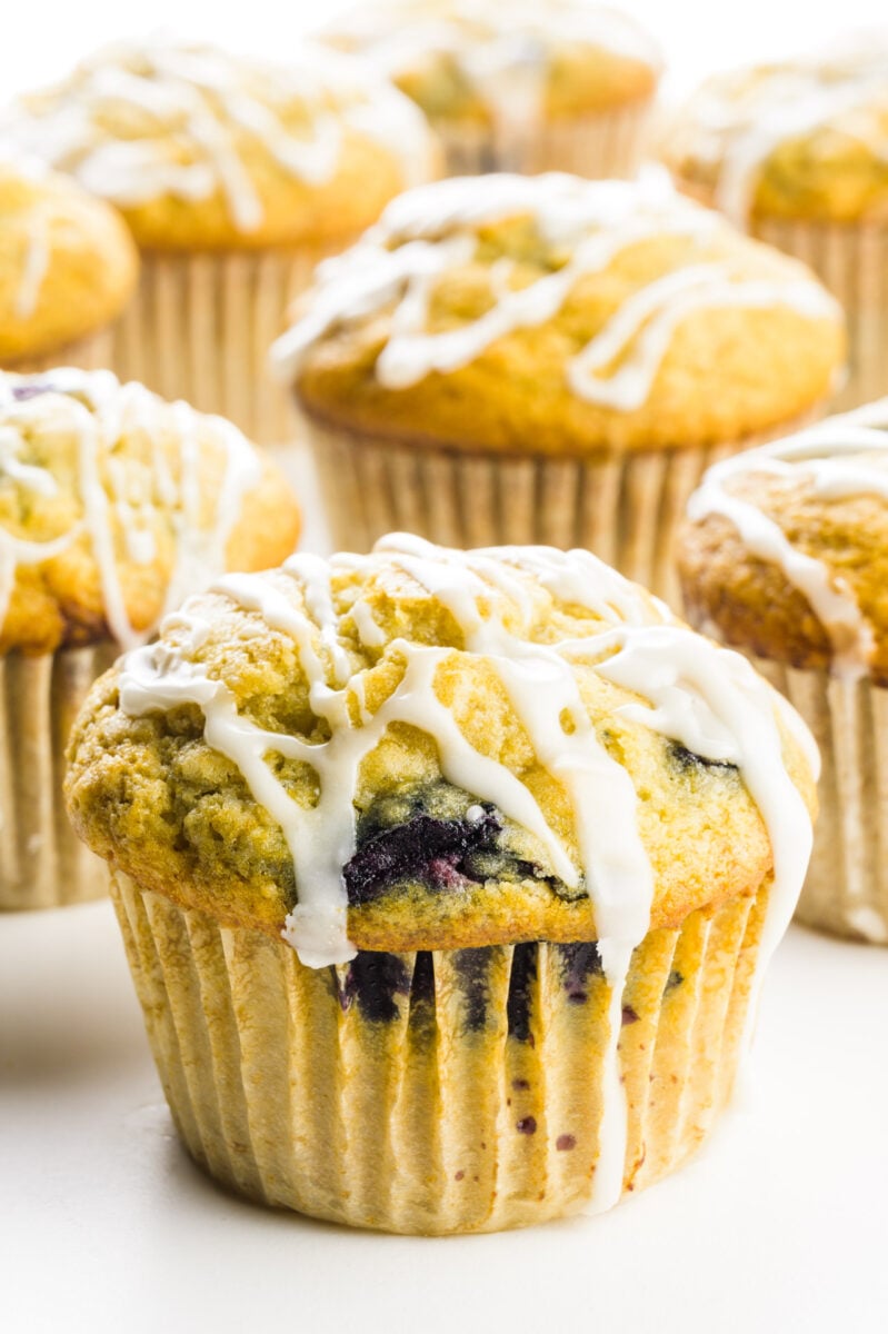 Several cherry muffins sit on a table top.