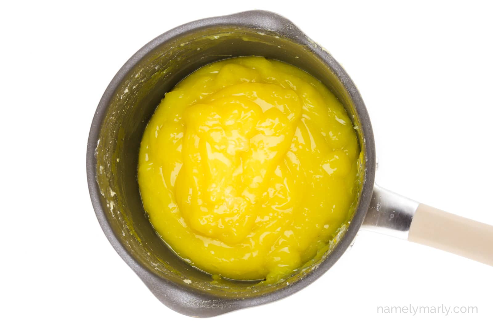 Vegan lemon curd in a saucepan.