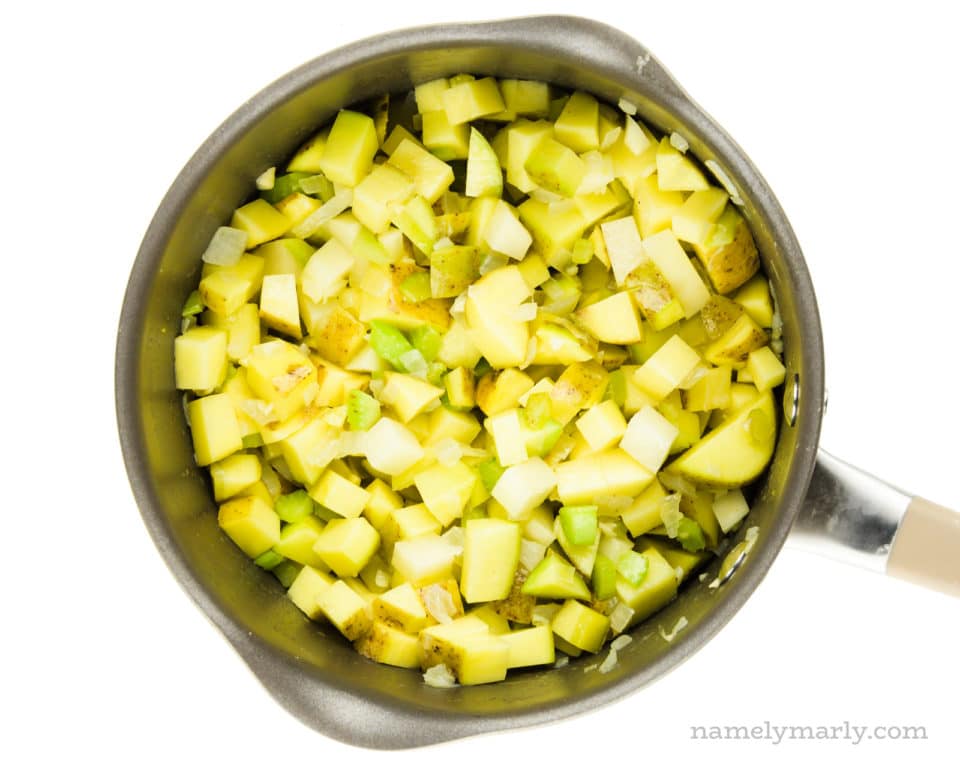 A saucepan holds chopped potatoes.