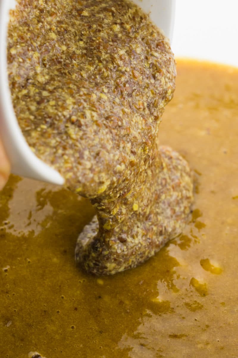 A flax egg is being poured into a batter.