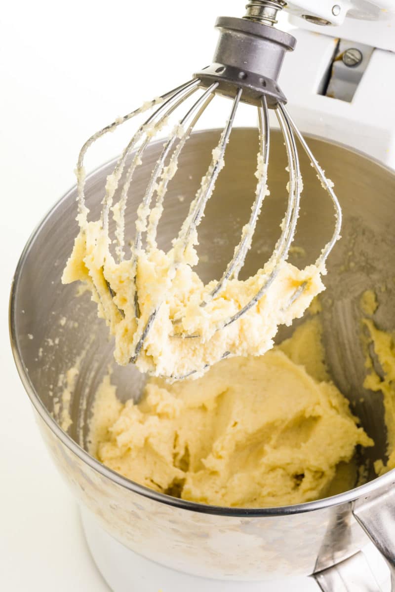 Butter and sugar have been whipped together in a mixing bowl of a stand mixer.
