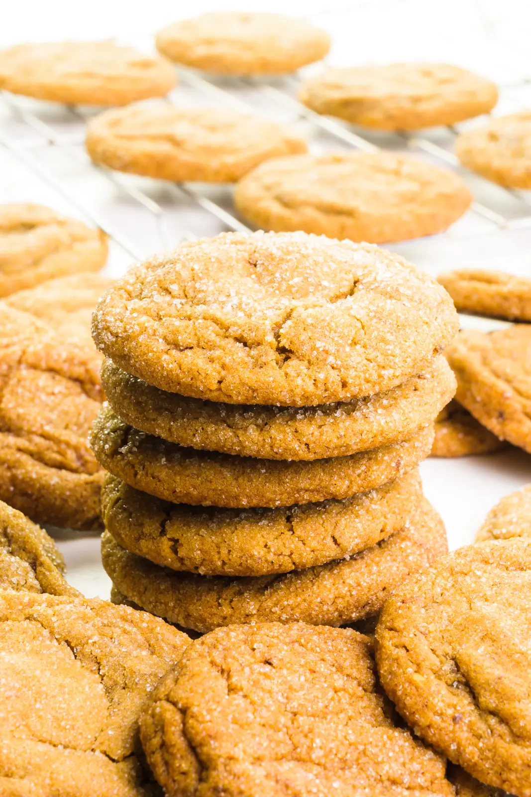 A stack of vegan spice cookies. There are more cookies in front and behind the stack.