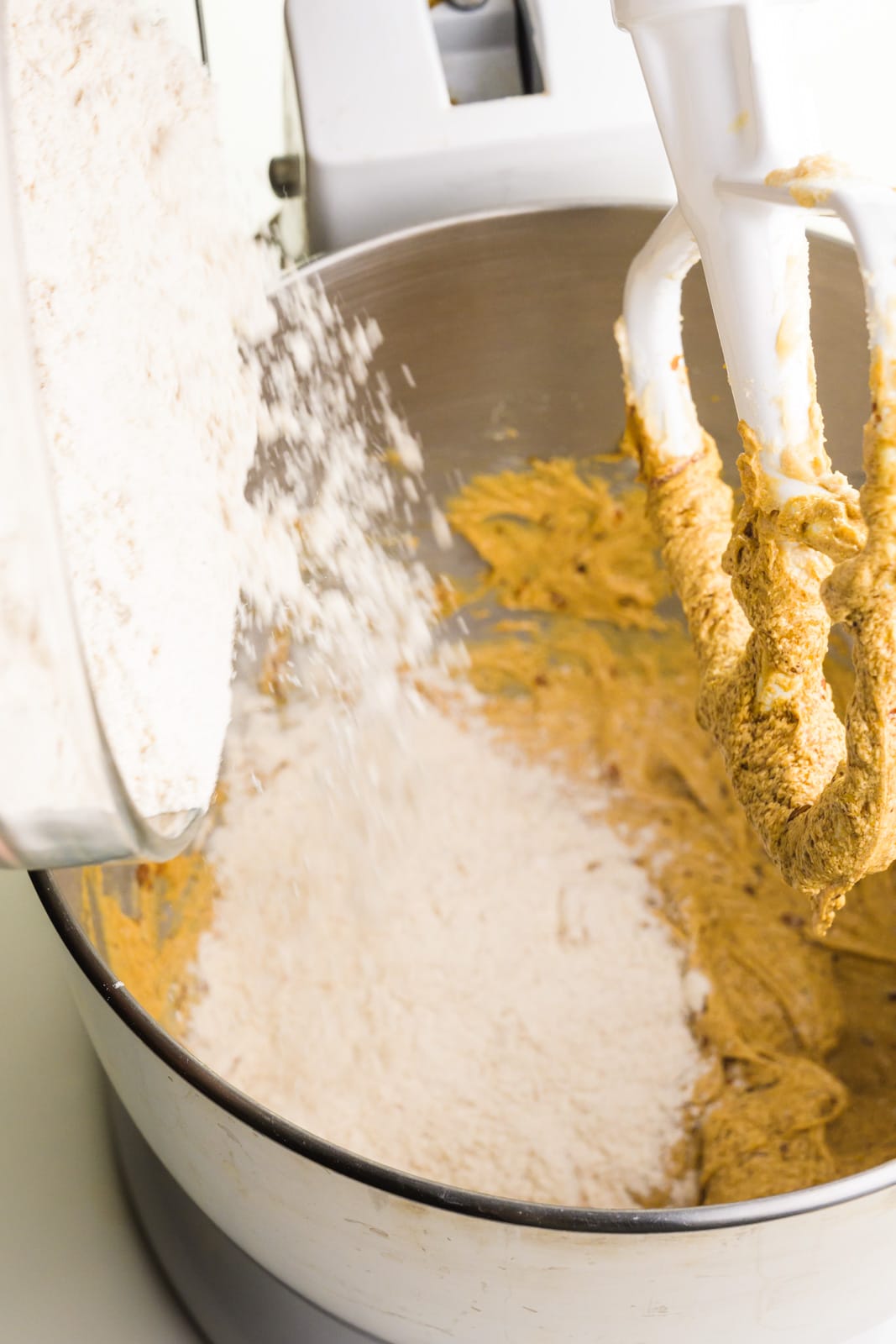 Dough is poured into a mixing bowl with cookie dough.
