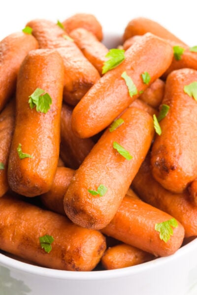 A close-up shot shows roasted balsamic carrots with fresh parsley on top.