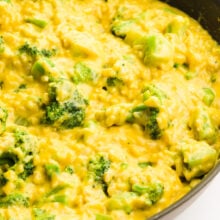 A skillet is full of vegan broccoli rice and cheese mixture.