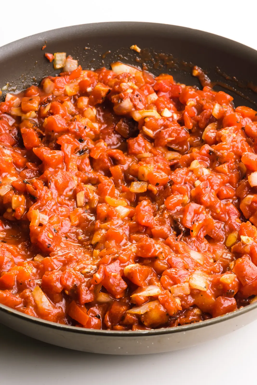 A tomato-based mixture is in a skillet.