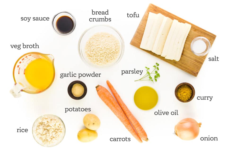 An image shows a spread of ingredients with labels next to them. The labels read, "soy sauce, vegetable broth, rice, potatoes, carrots, onion, curry, garlic powder, salt, tofu, olive oil, bread crumbs, and parsley."