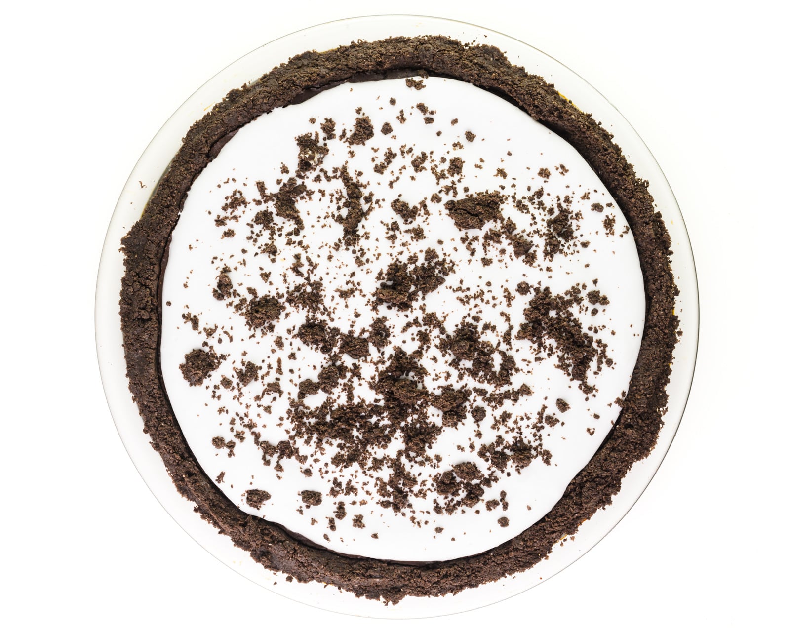 Looking down on a chocolate pie in an Oreo crust, with whipped cream on top and chocolate cookie crumbles.