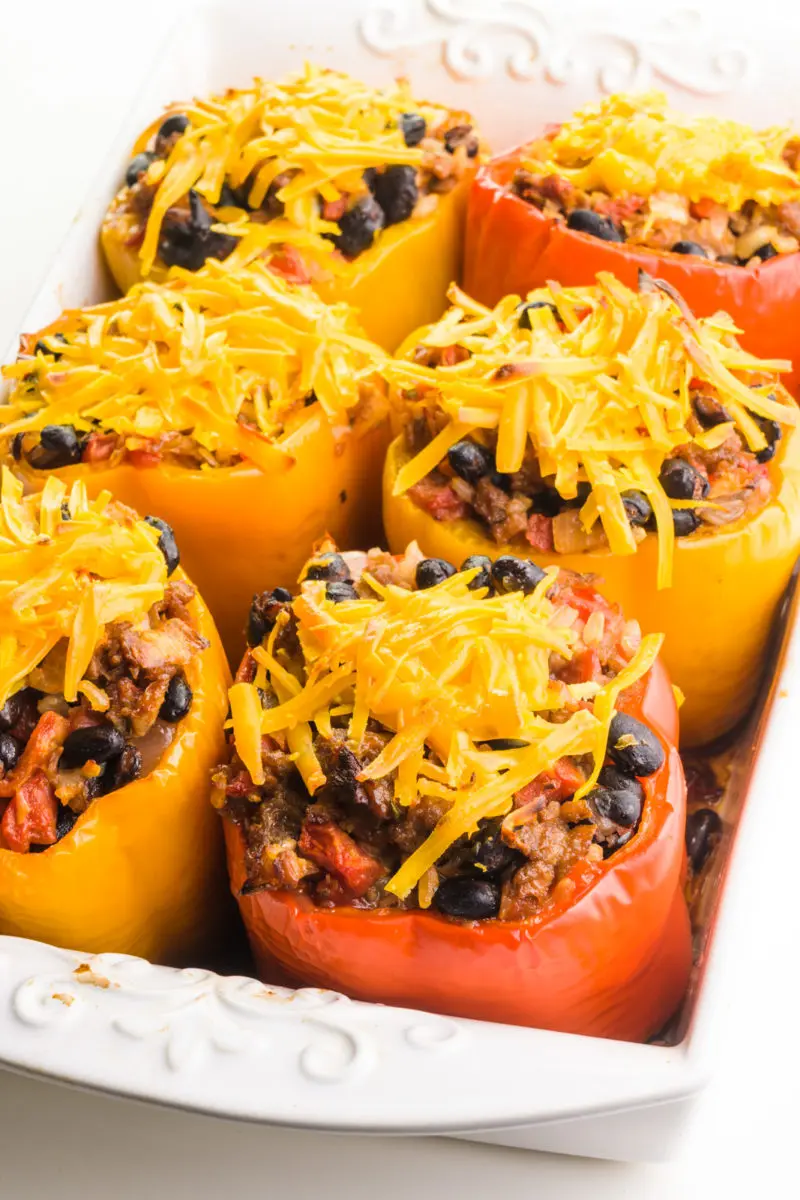 Vegan Italian stuffed peppers sit in a baking dish, just removed from the oven.