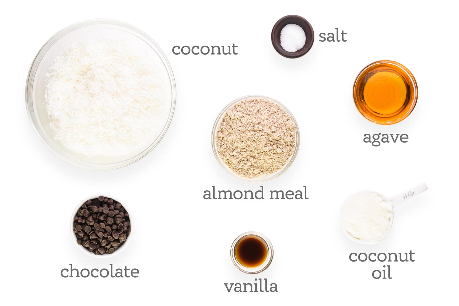 Ingredients are laid out. The labels read, "coconut, salt, agave, almond meal, coconut oil, vanilla, and chocolate."