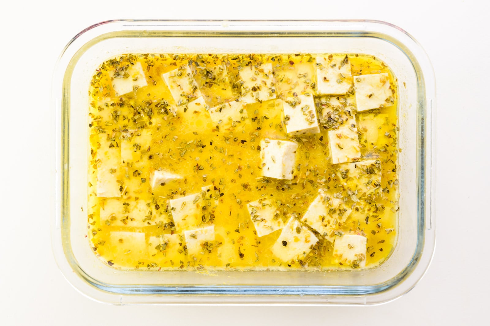 Tofu cubes are marinating in a broth with spices and other flavorings.
