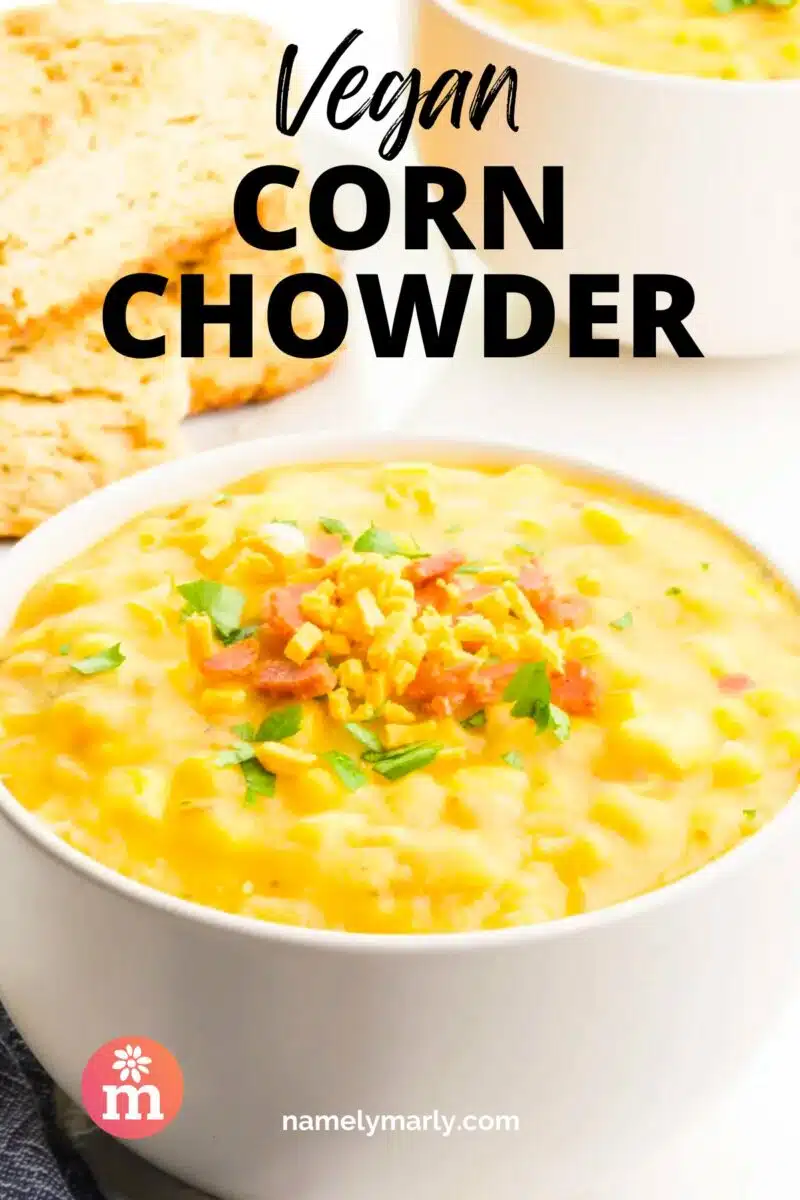 A bowl of chowder has chopped veggies on top. The text reads, Vegan Corn Chowder.