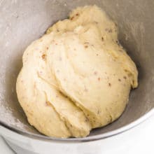 Dough is in the bottom of a bowl.