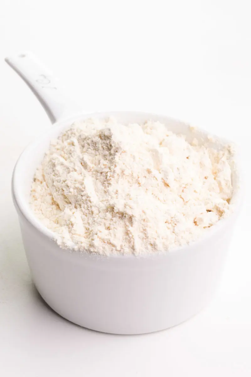 A measuring cup holds whole wheat pastry flour.