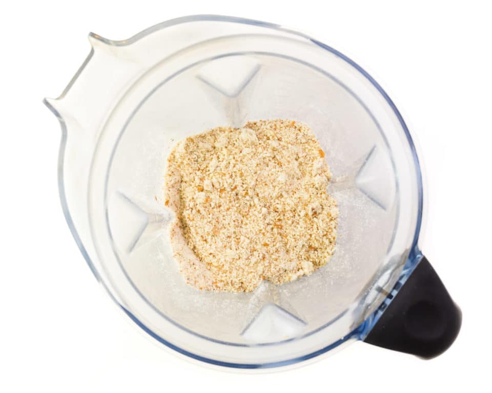 Looking down on a blender with almond meal in the bottom.