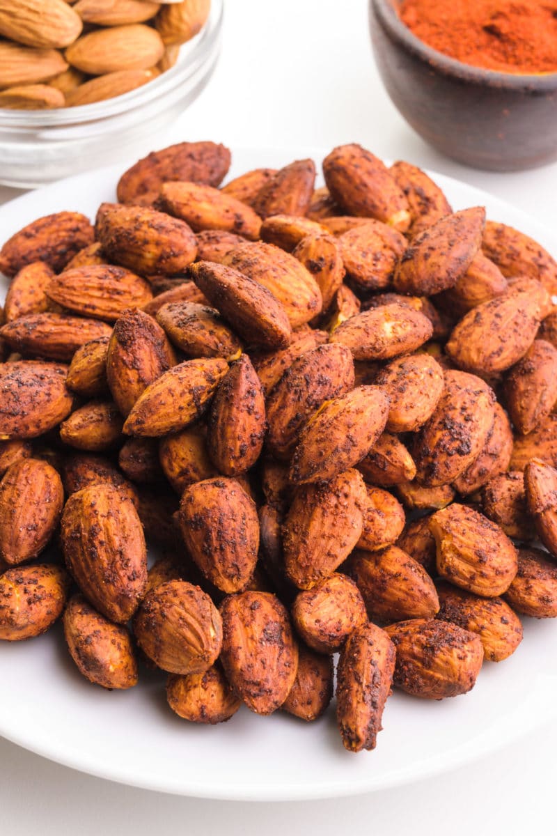 Looking down on a bowl of baked spiced almonds.