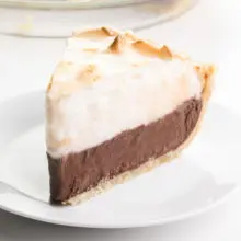 A slice of vegan chocolate meringue pie sits on a plate.