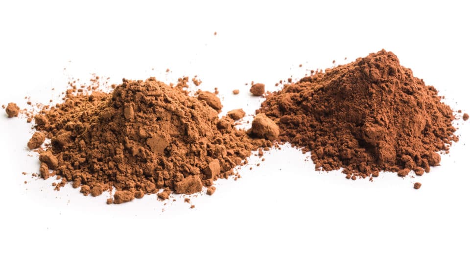 Two mounds of cocoa powder show the difference between natural cocoa powder (on the left) and Dutch-processed cocoa powder (on the right).