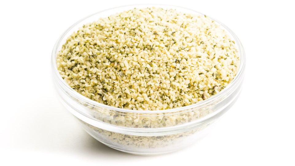 A bowl holds hemp seeds. It's sitting on a white counter.