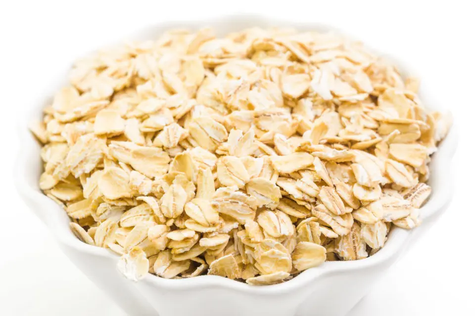 A bowl is full of old-fashioned oats, waiting to be cooked.