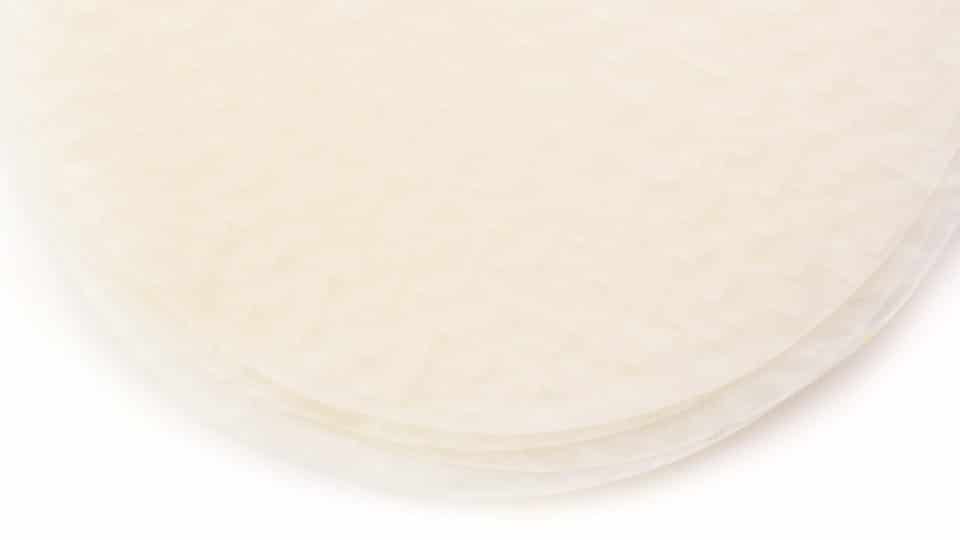 Looking down on a stack of rice papers on a white counter.