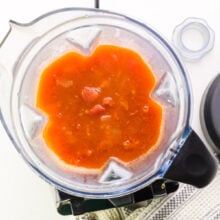 Looking down on a blender with blended tomato soup in it.
