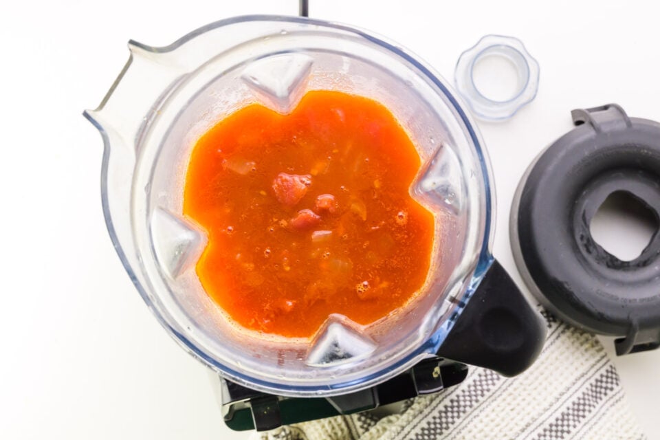 Looking down on a blender with blended tomato soup in it.