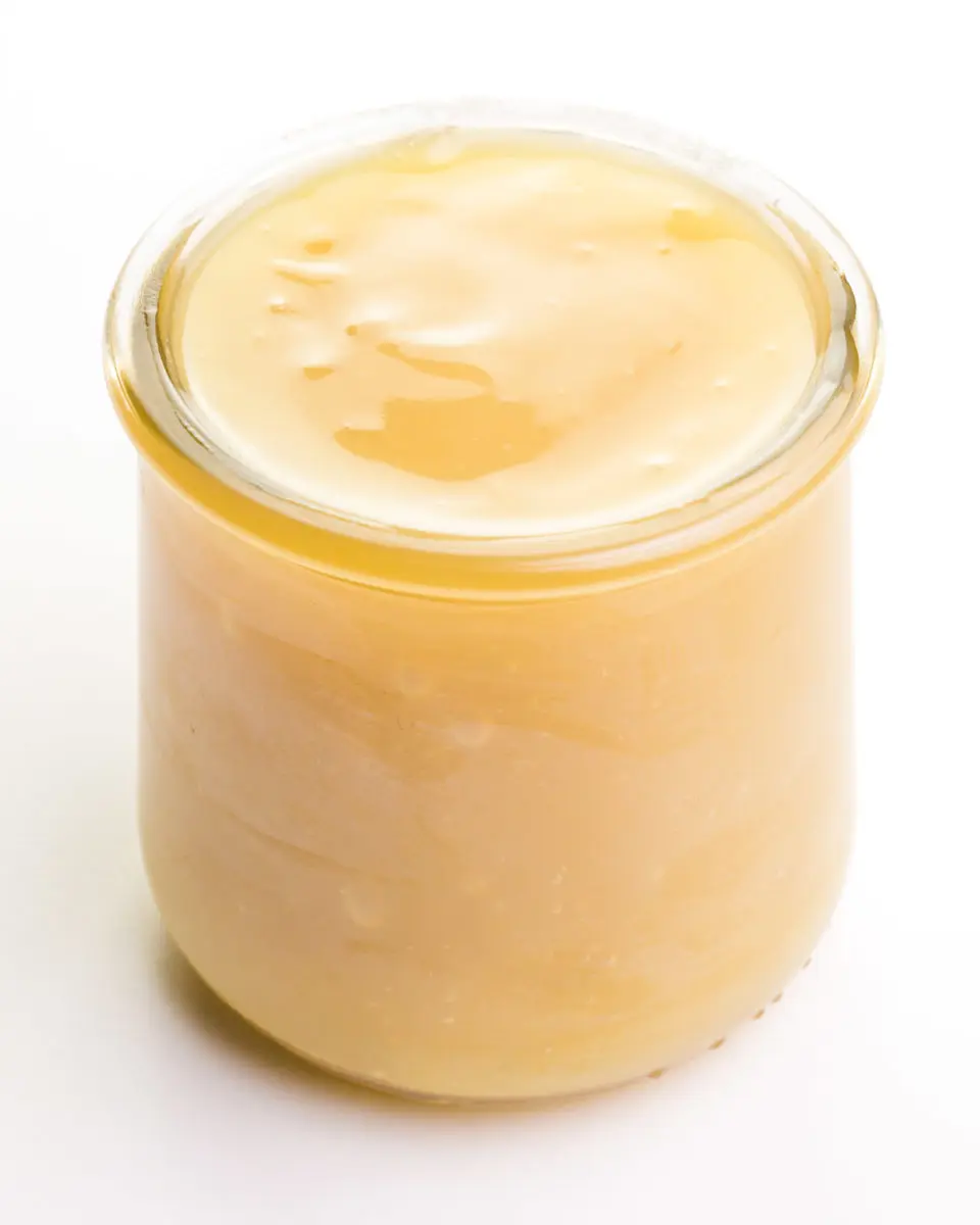 A small glass jar holds vegan sweetened condensed milk.