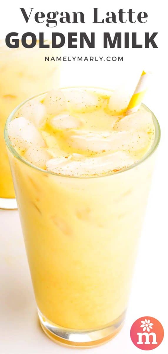 Glasses of golden milk sit on a white counter with yellow paper straws.