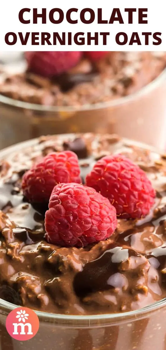 A closeup shot shows chocolate oatmeal in a bowl with chocolate drizzles and fresh raspberries on top. There's another bowl in the background. The text at the top of the image reads, Chocolate Overnight Oats.