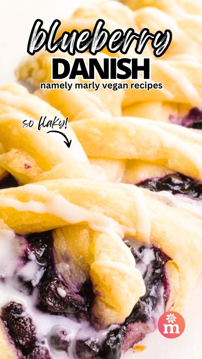 A closeup of a danish with blueberry filling has an arrow next to the words, So Flaky! The text at top reads, Blueberry Danish, Namely Marly Vegan Recipes.