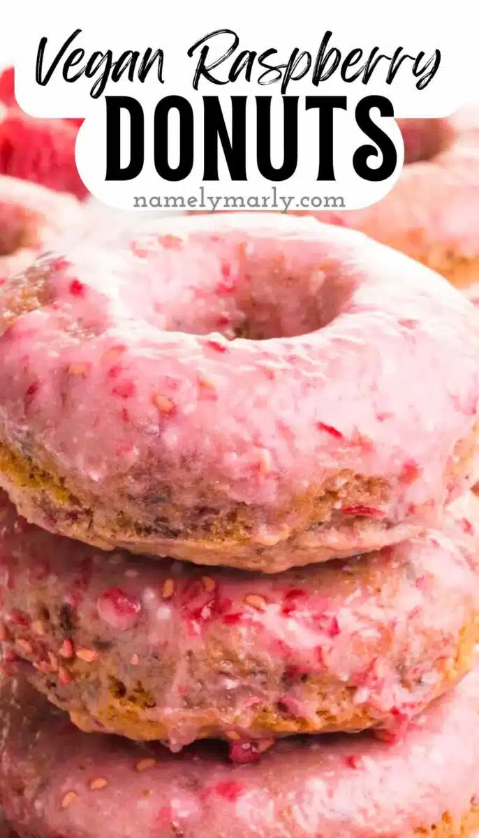 A closeup of a stack of raspberry donuts. The text reads, Vegan Raspberry Donuts.