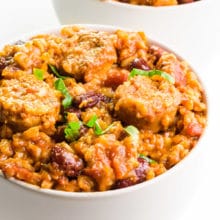 A bowl of vegan jambalaya sits in front of another bowlful.