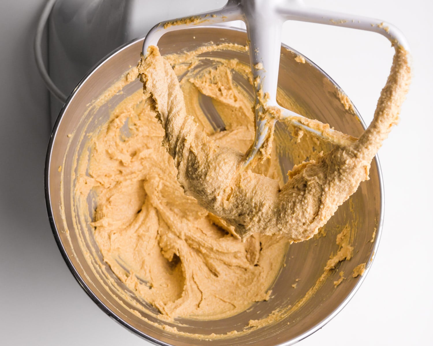 Whipped peanut butter in a stand mixer bowl.