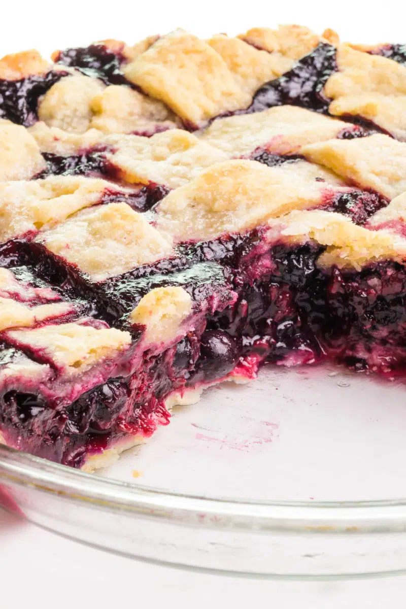 Looking into a berry pie with a few slices cut out.