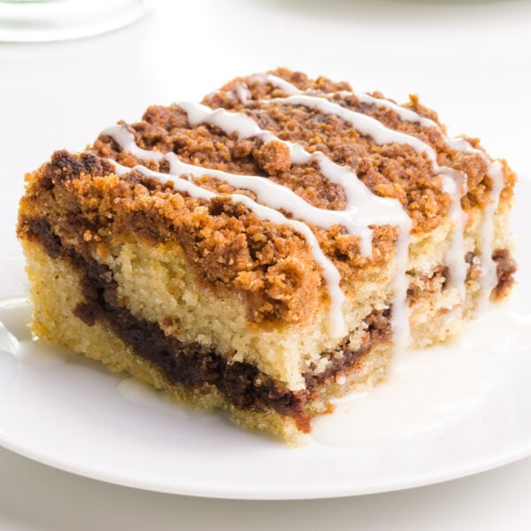A slice of coffee cake sits on a plate.