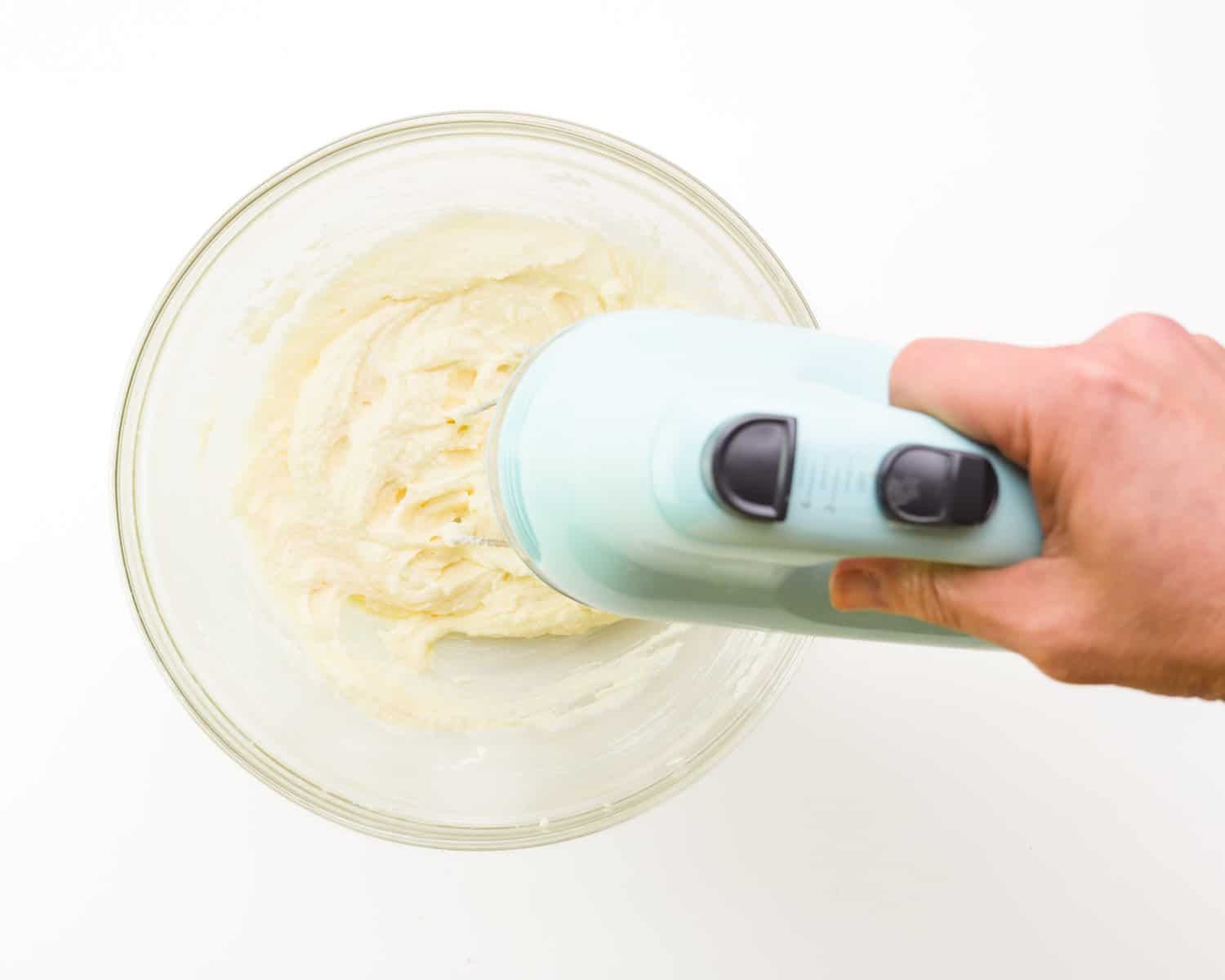 Vegan butter is being creamed with an electric mixer.
