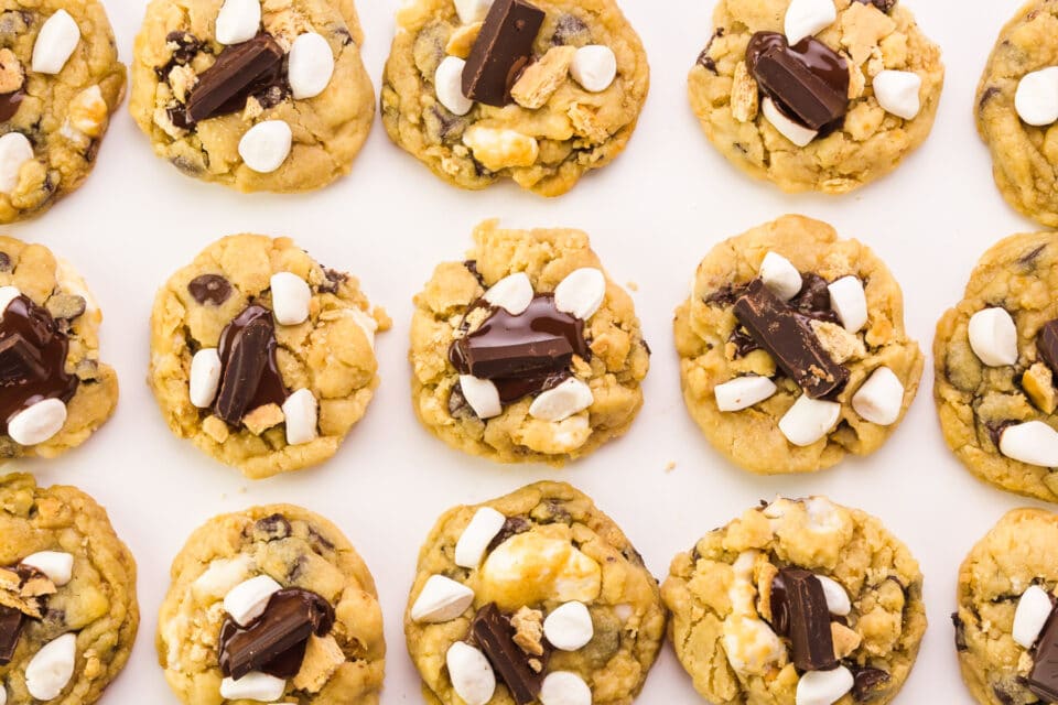 Looking down on rows of cookies with chocolate chunks and marshmallows on each.