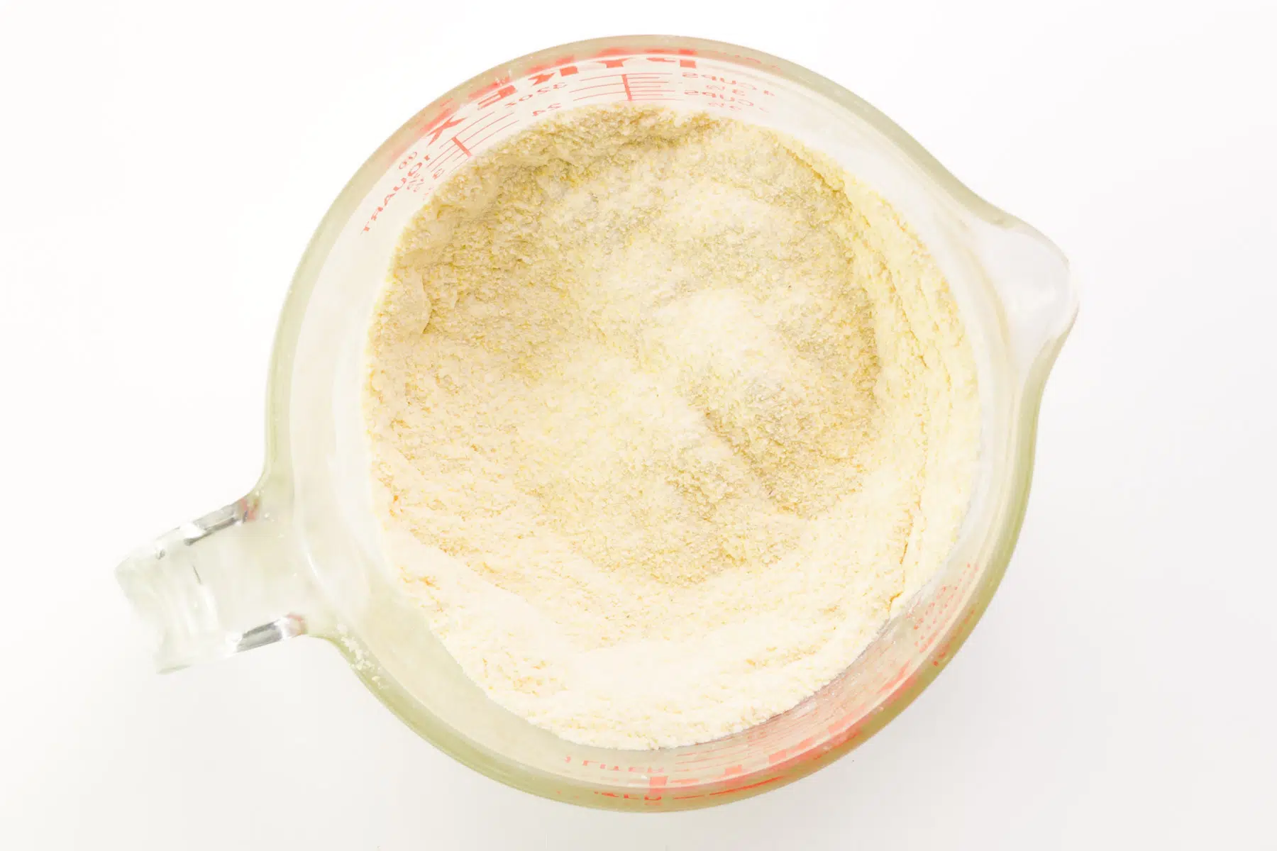 Cornstarch and flour have been mixed in a bowl along with other ingredients.