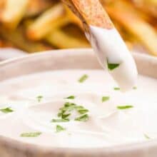 A French fry is being dipped in a creamy sauce. The text on the page reads, Ready Quickly Vegan Aioli.