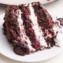 A slice of vegan Black Forest cake sits on a plate.