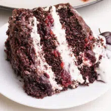 A slice of vegan Black Forest cake sits on a plate.